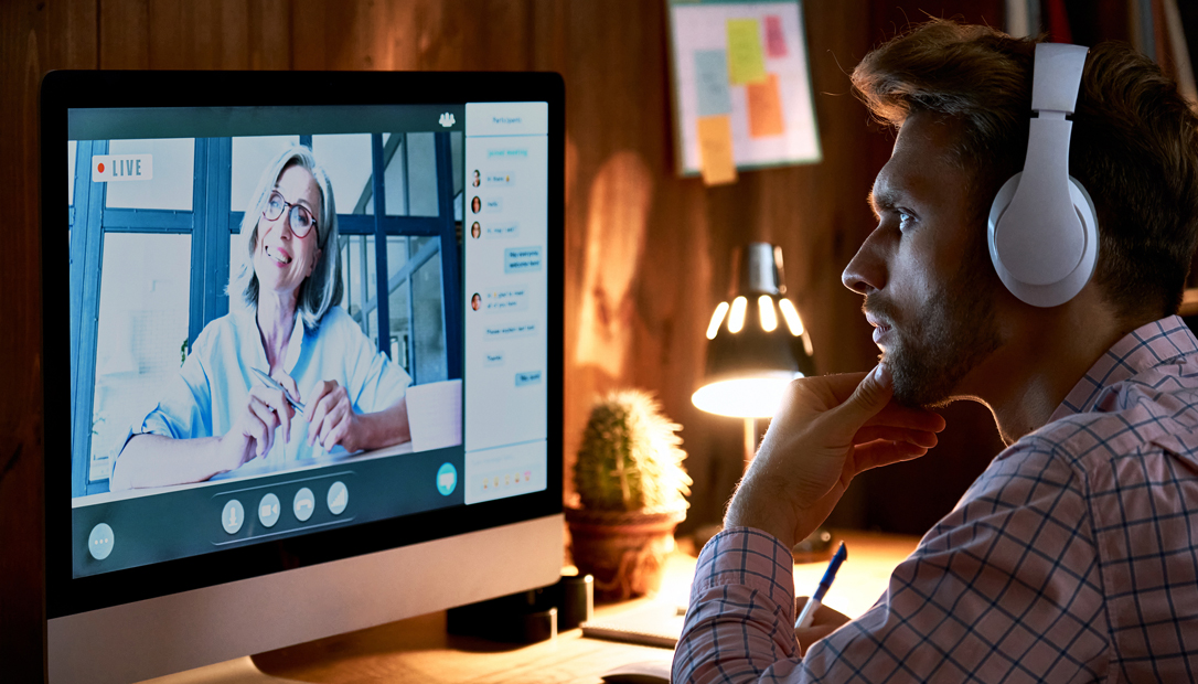 Student meeting with an academic advisor during a video call on a computer