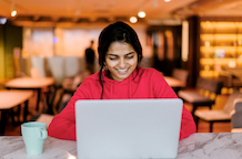  Indian woman working on a laptop in a coffee shop 
