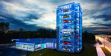 Carvana vending machine lit up at dusk