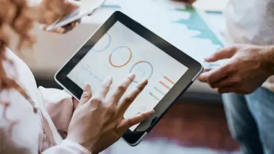 Closeup of a hand using a tablet with circle graphs on the screen.
