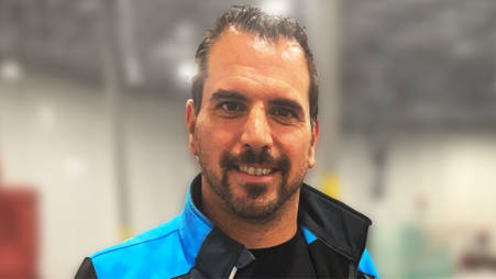 Closeup of Mario N., the Hispanic DSP owner who provided the image quote, smiling at the camera.